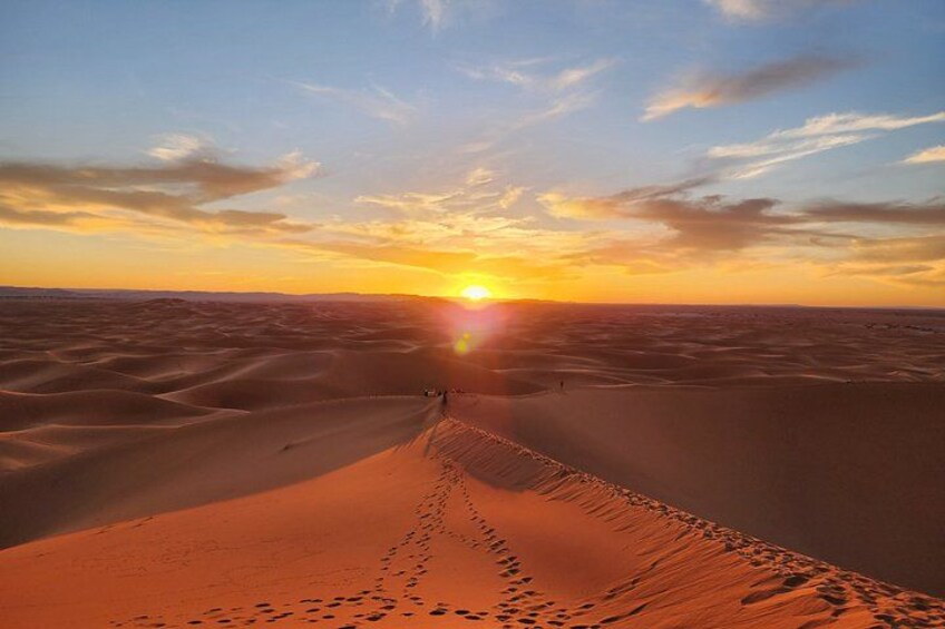 A desert landscape with sand dunes and a sunset. 2