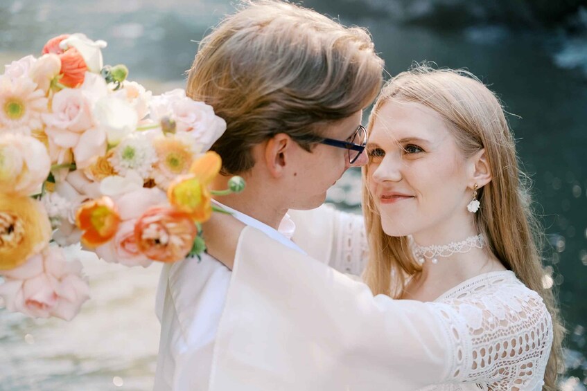 A couple holding a bouquet of flowers. 2