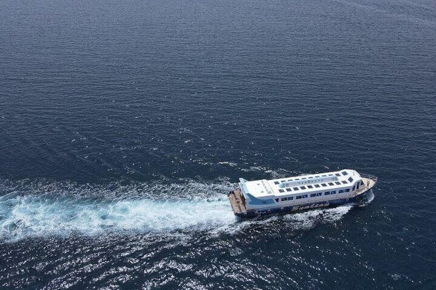 A white cruise ship traveling on a calm body of water. 2
