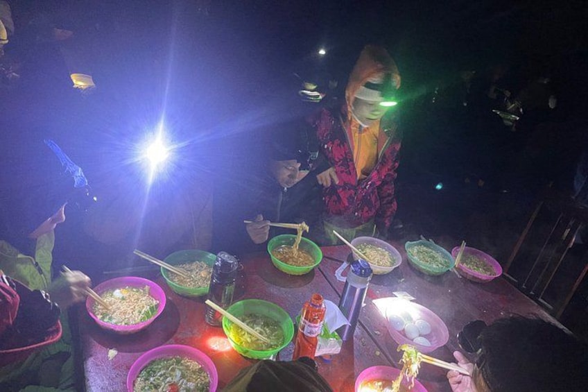 A group of people dining at a restaurant with various dishes on the table. 4