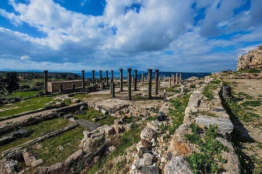 Ancient ruins with columns and stone structures. 5