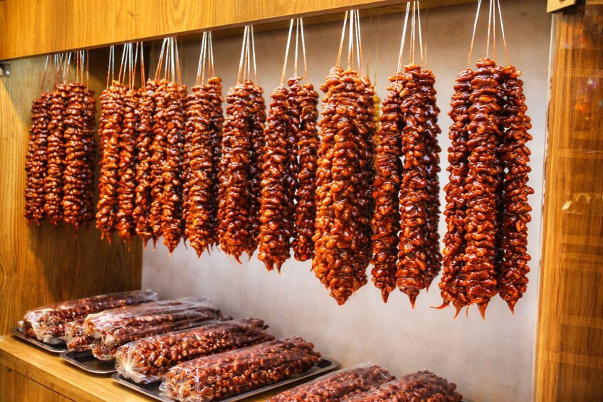 Hanging sausages and packaged sausages on display. 5