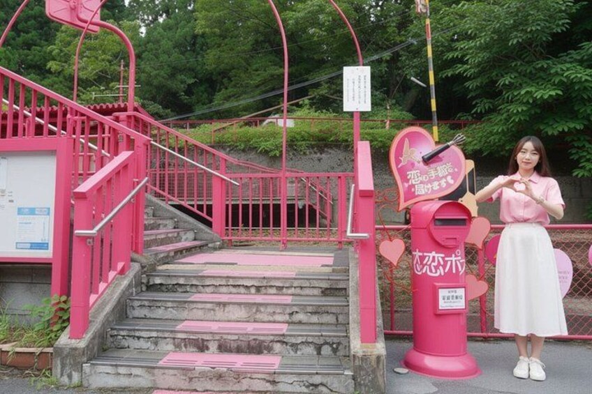 A pink staircase with a mailbox and a sign. 2
