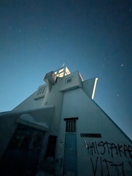 A building with graffiti and a starry night sky. 4