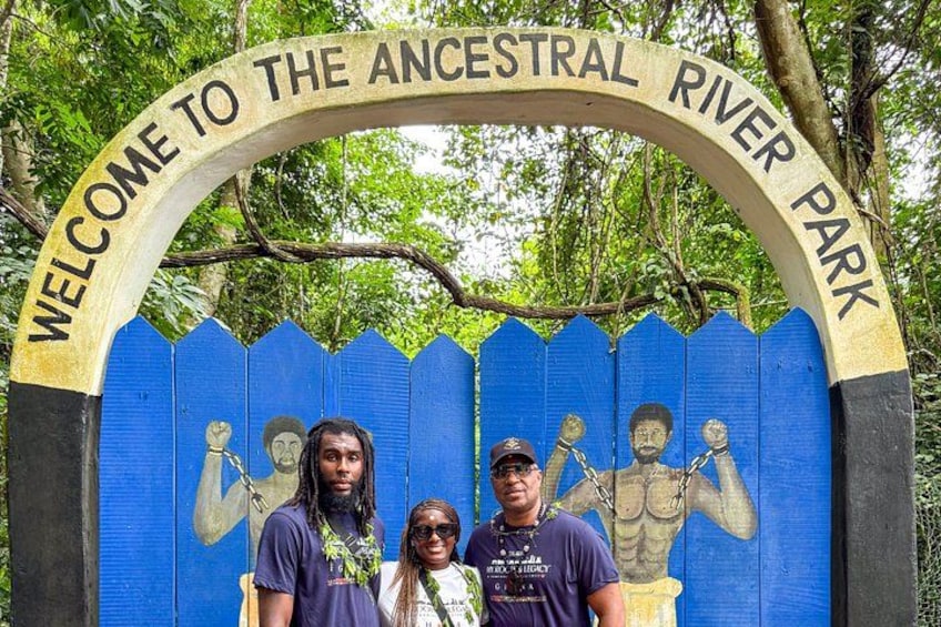 A sign reading 'WELCOME TO THE ANCESTRAL RIVER PARK' with a blue fence and a mural of people in the background. 5