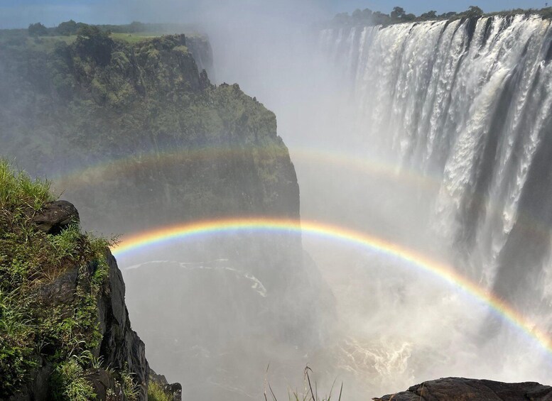 A waterfall with a rainbow. 1