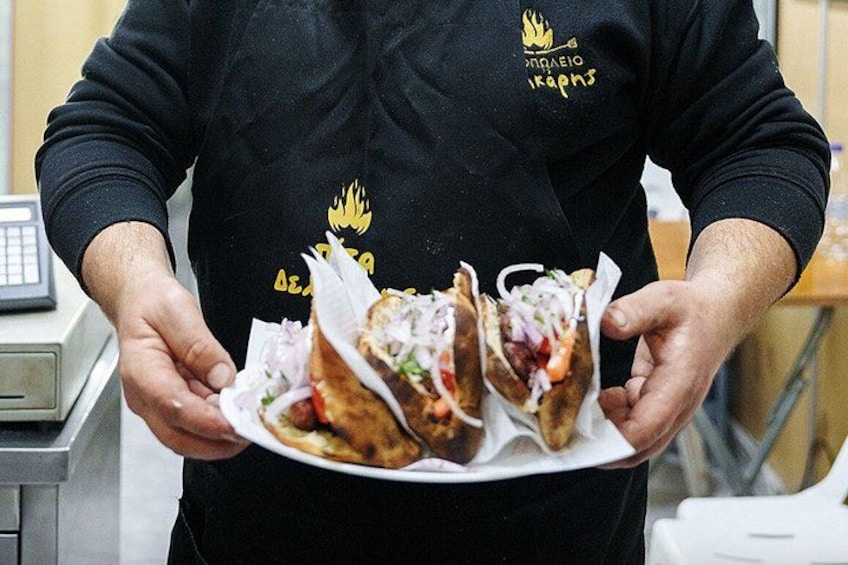 A person holding a plate with three sandwiches. 4