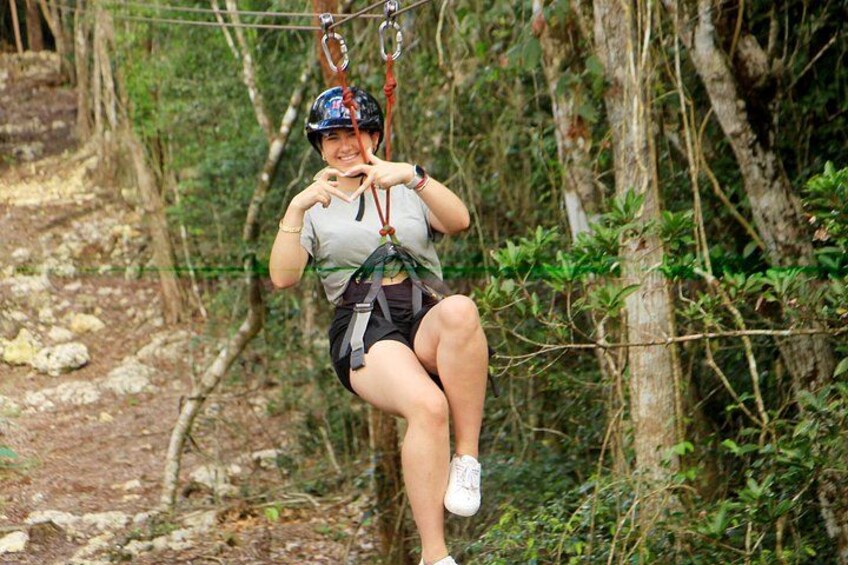A person zip-lining through a forested area. 5