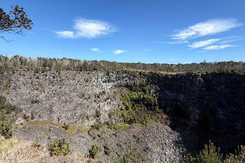 A rocky landscape with sparse vegetation and a clear blue sky. 4