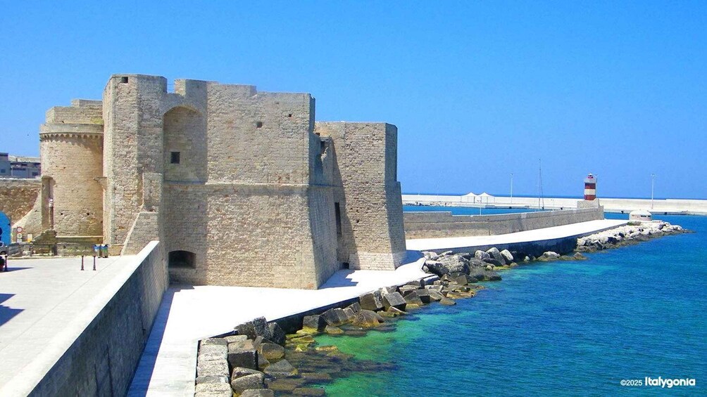 A coastal fortification with a lighthouse in the background. 1