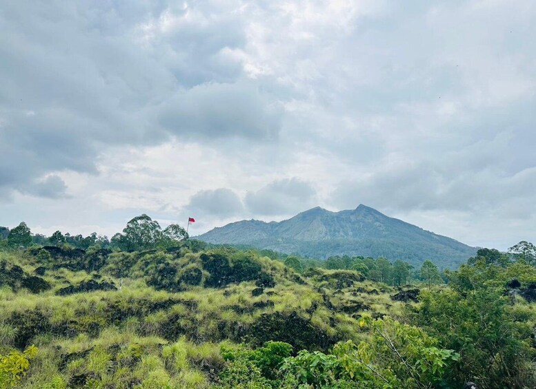 A mountain landscape with a flag on a hill. 5