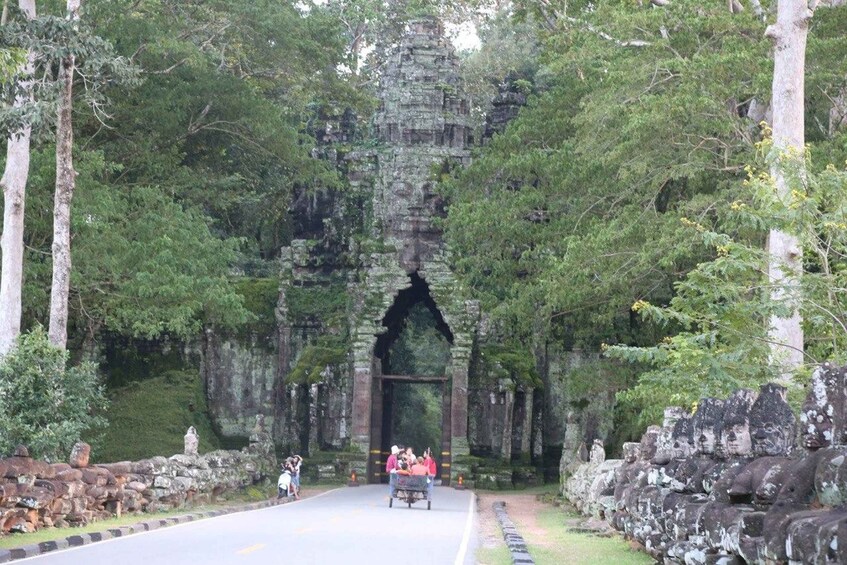 A stone structure with an archway surrounded by trees. 2