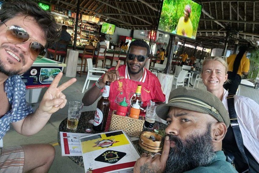 People sitting at a table with drinks and a menu. 2