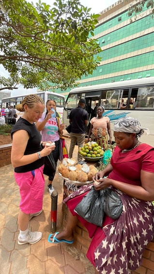 A street market with people buying and selling goods. 5