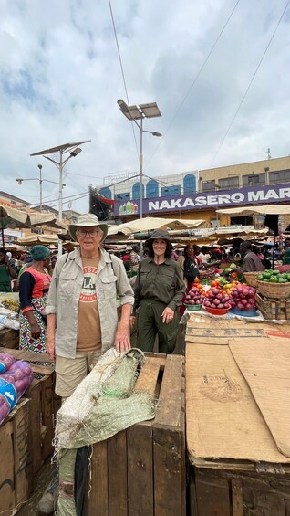 An outdoor market with vendors and customers. 4