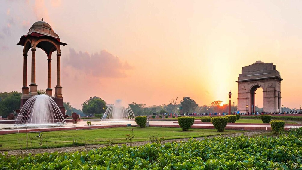 A park with fountains, an arch monument, and a gazebo. 5
