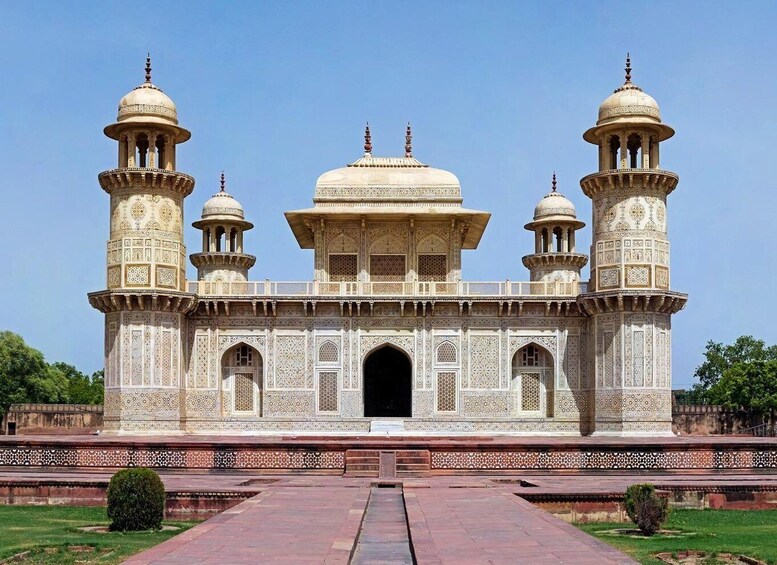 A large, ornate building with multiple domes and minarets, featuring intricate tile work and a central archway. 5