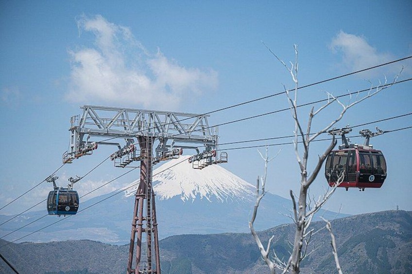 A cable car system with a snow-capped mountain in the background. 2