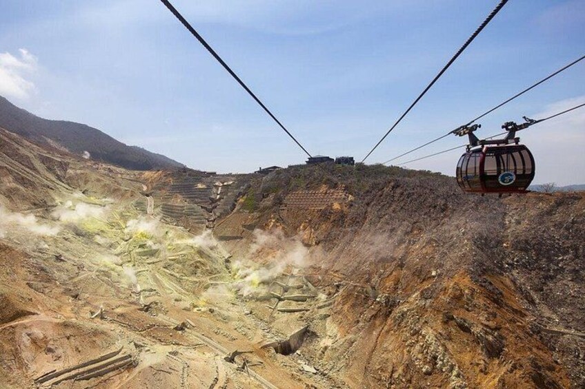 A cable car in a mountainous area with a large open pit. 3