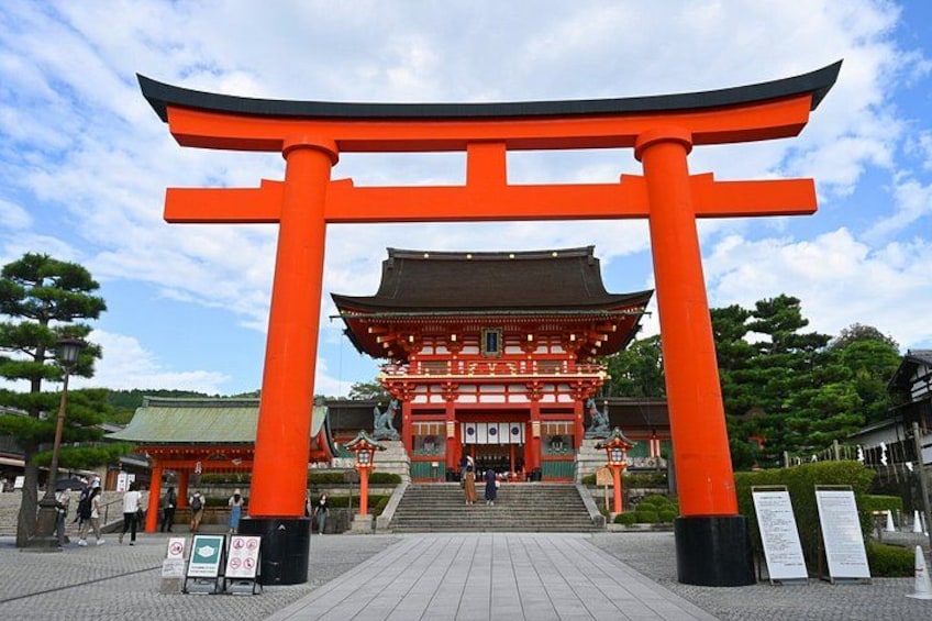 A traditional Japanese building with a prominent red torii gate in front. 5