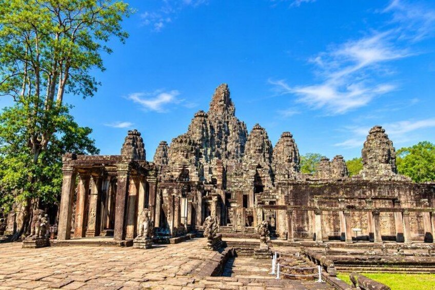 A large, ancient temple complex with multiple towering structures and intricate carvings. 1