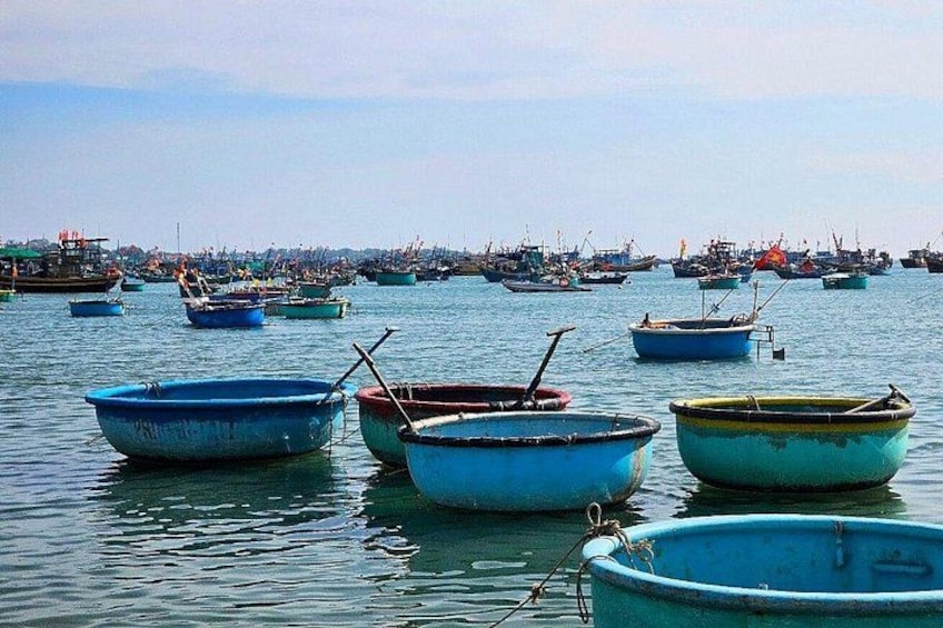A harbor with multiple small boats anchored in calm waters. 3