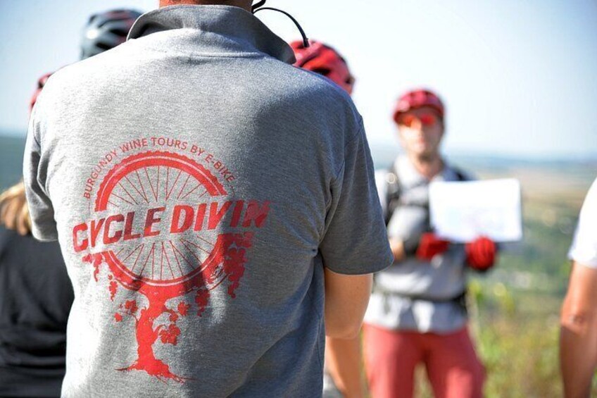 A person wearing a cycling jersey with 'CYCLE DIVIN' and 'BURGUNDY WINE TOURS BY F-BIKE' text. 2