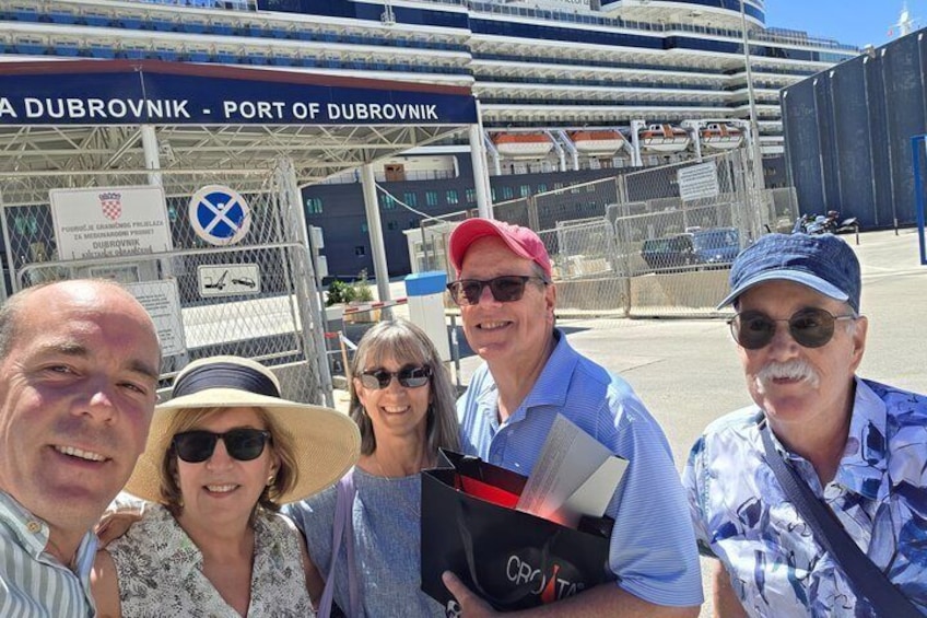 A group of people in front of a port with a sign reading 'Port of Dubrovnik.' 3