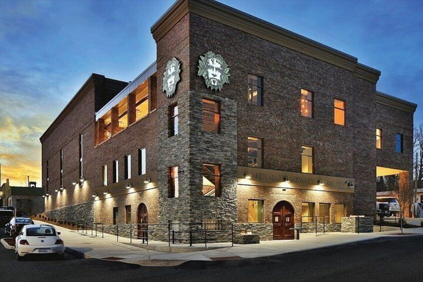A brick building with a clock tower, arched windows, and a sign that reads 'Brewery.' 3