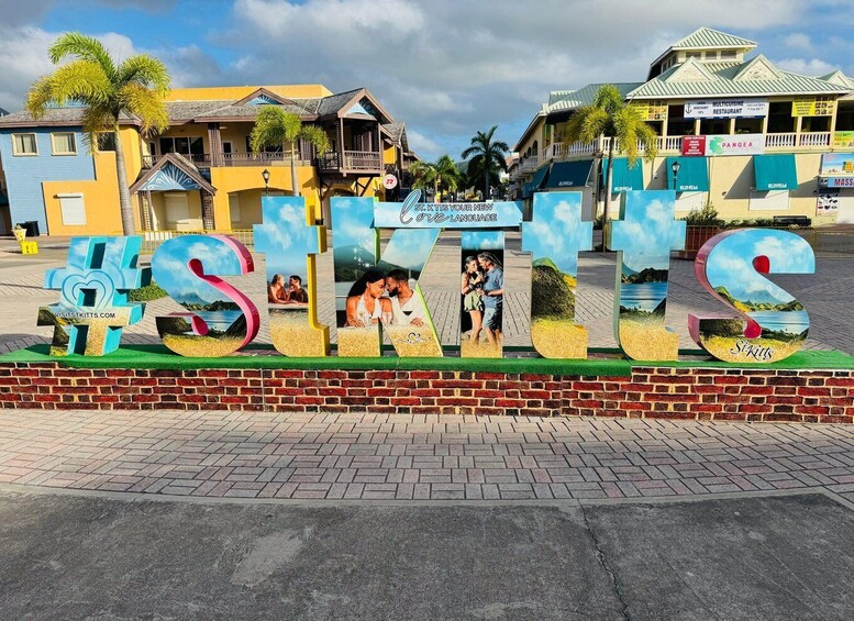A colorful sign with the word "SITKITS" and images of people enjoying the beach. 1
