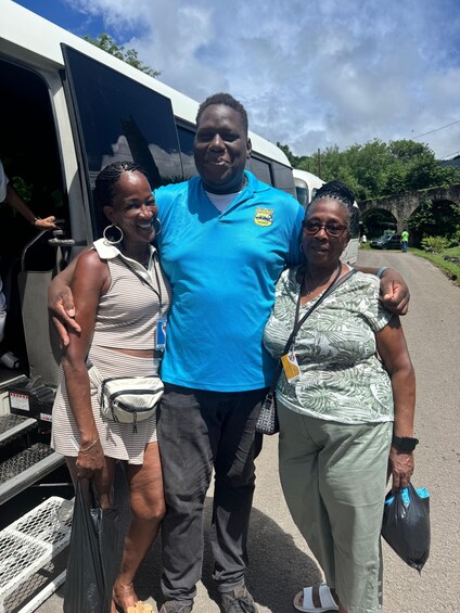 Three people standing in front of a vehicle with a logo on the shirt of the person in the middle. 3