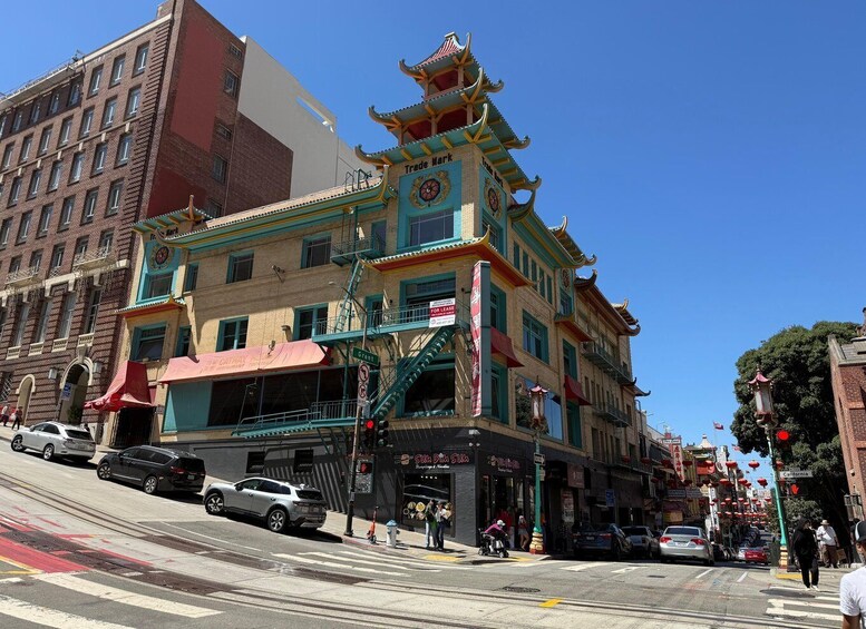 A multi-story building with a traditional Asian architectural style, including a pagoda-like roof and a sign that reads 'Trade Mark.' 2