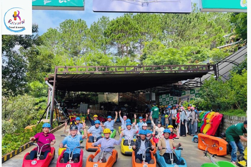 People in colorful ride-on vehicles at an outdoor event. 4
