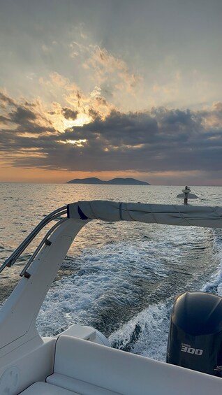 A boat on the water with a sunset in the background. 4