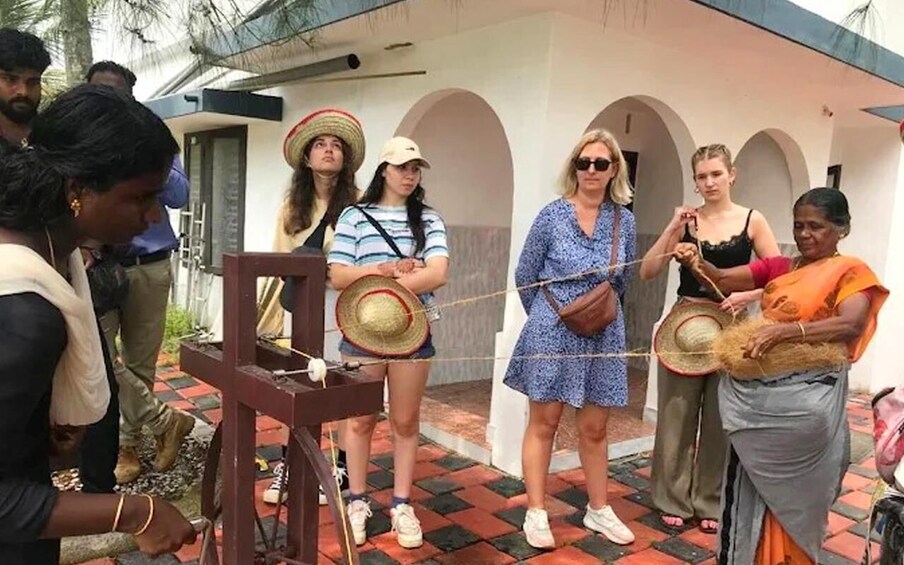 A group of people participating in a traditional weaving activity. 1