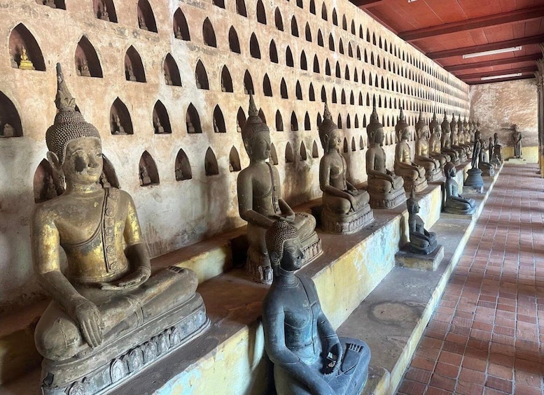 A row of seated Buddha statues in a temple. 5