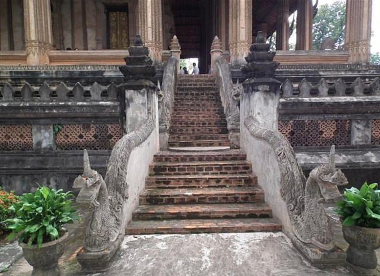 A staircase with ornate balustrades and stone lions at the base. 3