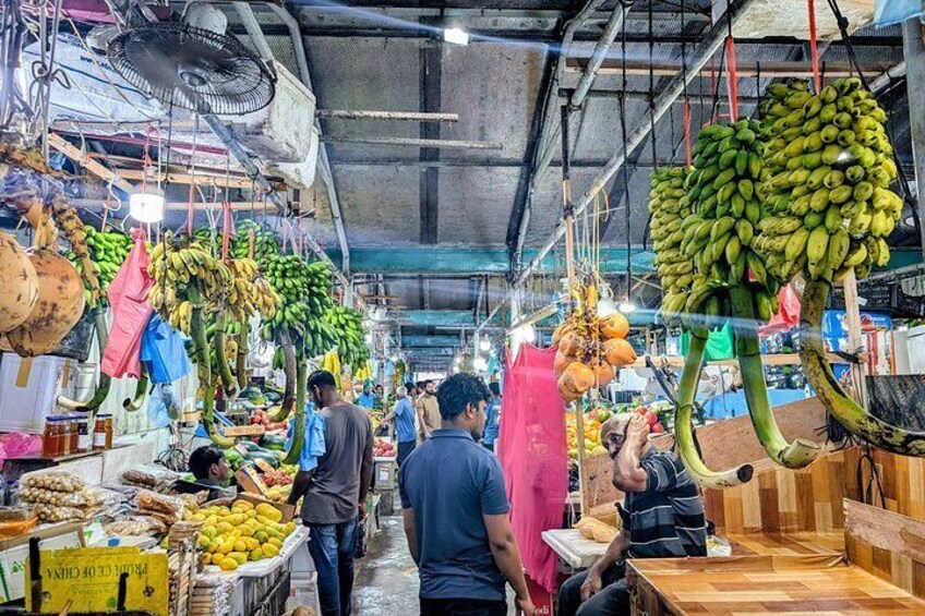 A market with hanging bananas and other fruits. 3