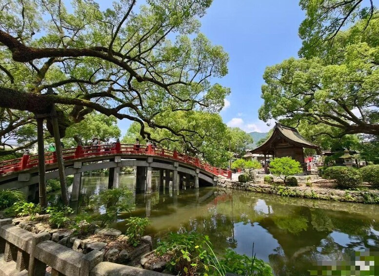 A traditional Japanese bridge over a pond, surrounded by lush greenery and a pagoda. 1
