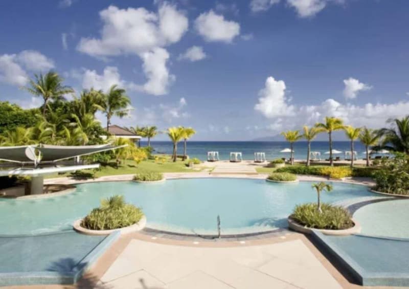 A resort pool with palm trees and lounge chairs. 3