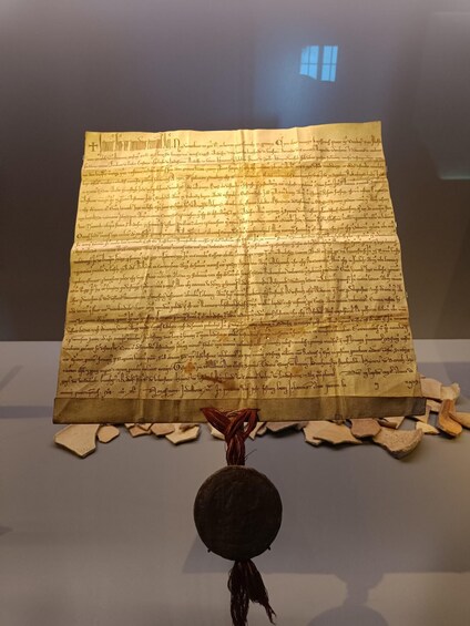 An ancient manuscript displayed in a museum. 5
