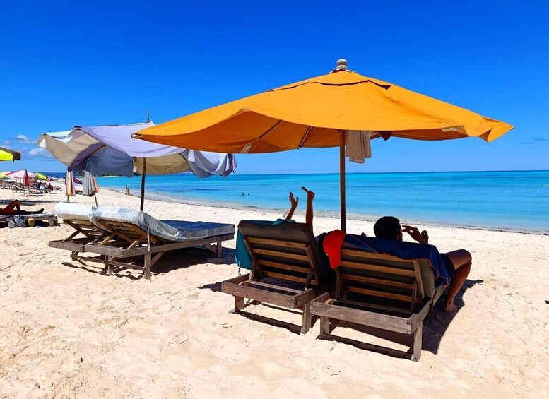 A beach with sun loungers and umbrellas. 2