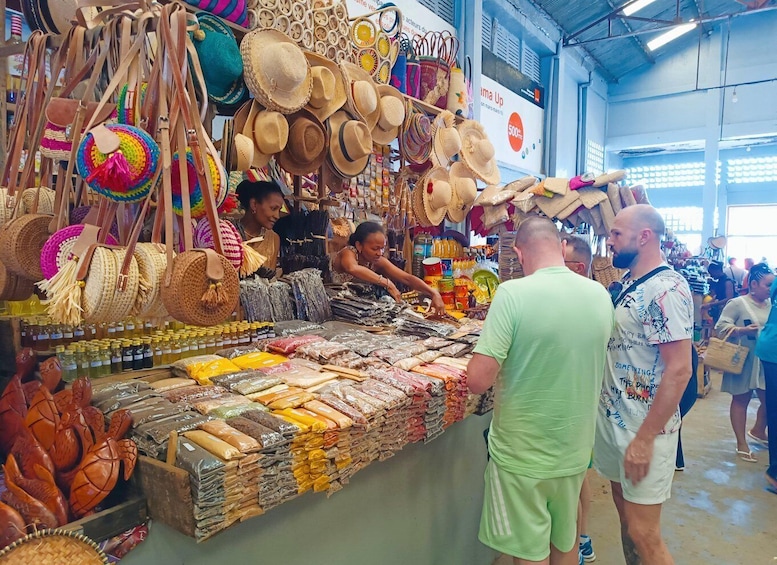 A market stall with various hats and bags. 1