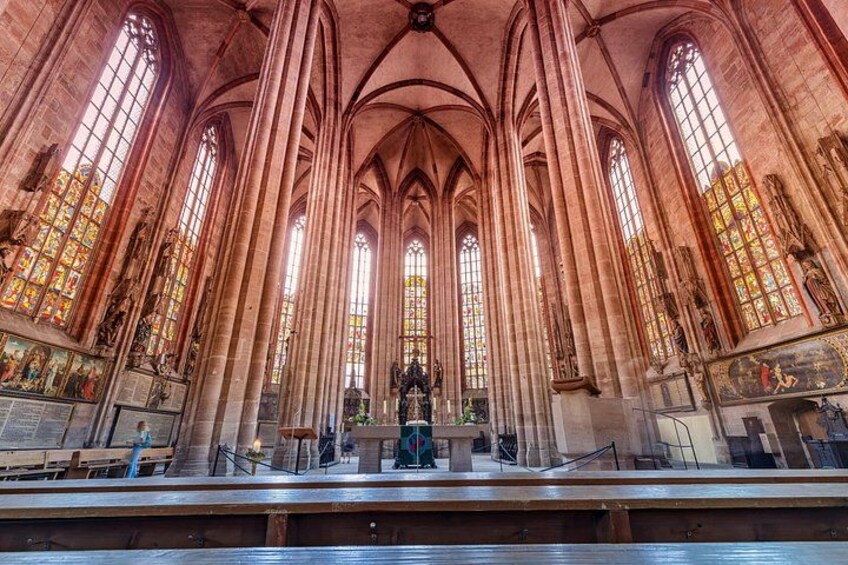 A cathedral interior with tall arched windows, stained glass, and a central altar. 5