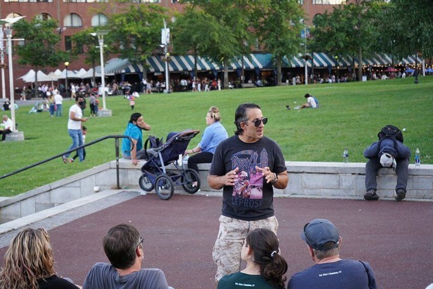 A park with people walking, sitting, and a stroller. 5