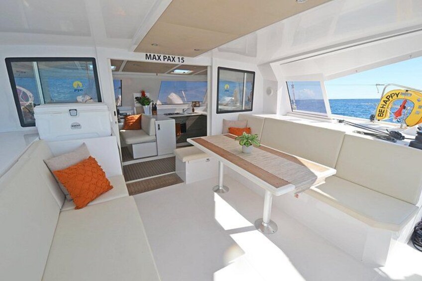 A modern interior with a white color scheme, a dining area, and a view of the sea. 2