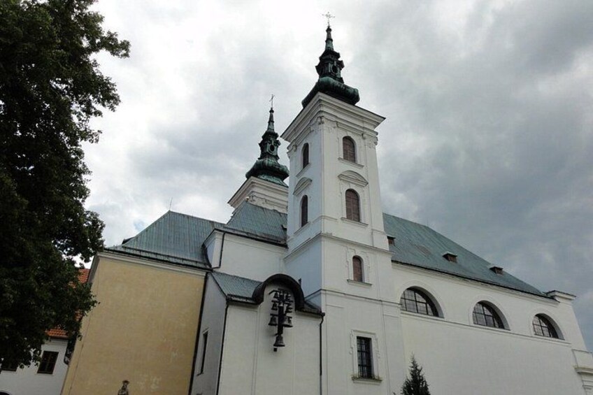 A white church with two towers and a green roof. 3