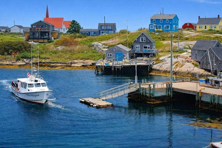A coastal town with a boat docked at a pier, houses, and a church steeple. 3