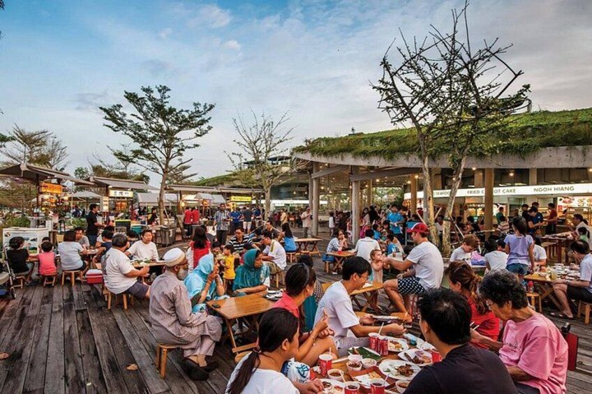 An outdoor dining area with people eating and socializing. 5