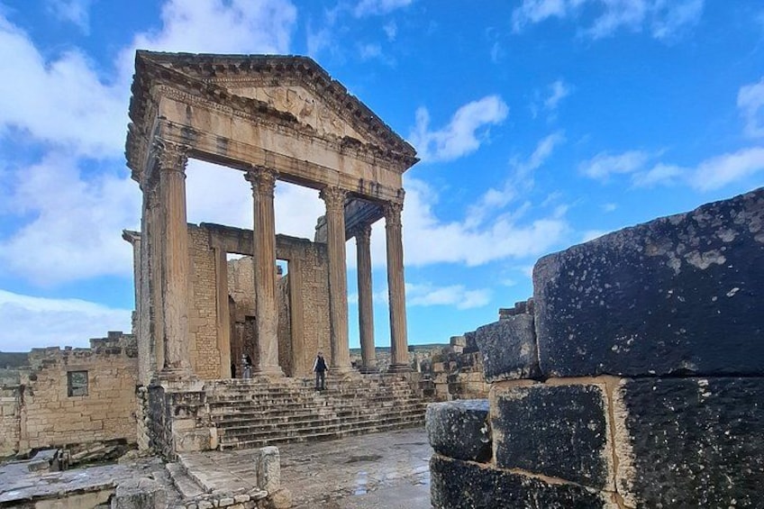 Ancient ruins with columns and stone steps. 1